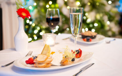 A plate of bread, fruits and cheeses as part of the Holiday Sparkle package.