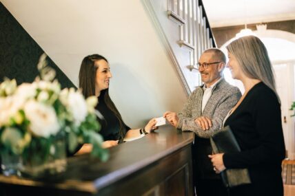 A couple checking in to The Charles Hotel in Niagara-on-the-Lake.